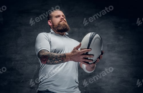 Preview: Portrait of bearded rugby player with tattoos on his arms