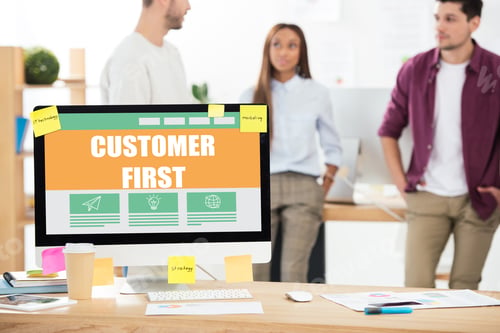 Preview: selective focus of customer first inscription on computer screen and multiethnic business colleagues