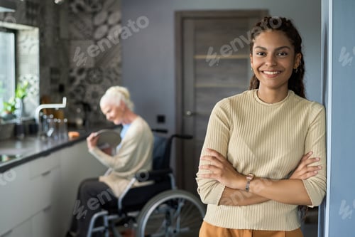 Preview: Young cheerful multiethnic teenage girl looking at camera in the kitchen