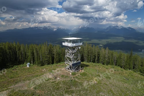 Preview: Aerial shot of Montana Fire Lookout tower with Glacier National Park wilderness behind