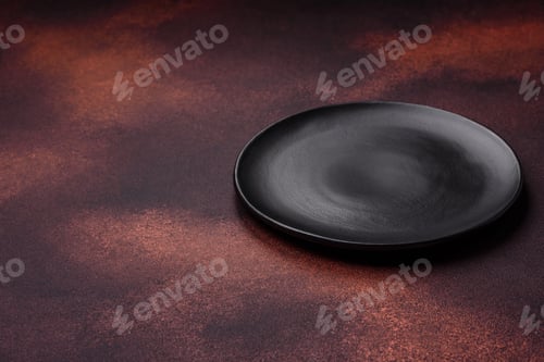 Preview: Empty ceramic round plate on dark textured concrete background