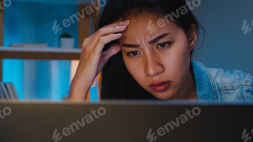 Preview: ํYoung businesswoman working late night stress out on laptop in living room at modern home.