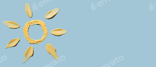 Preview: Cosmetic smear of cream texture in the form of a yellow sun on a blue background. Sunscreen cream.