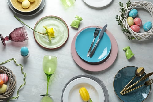 Preview: Festive Easter table setting with painted eggs on wooden background, top view
