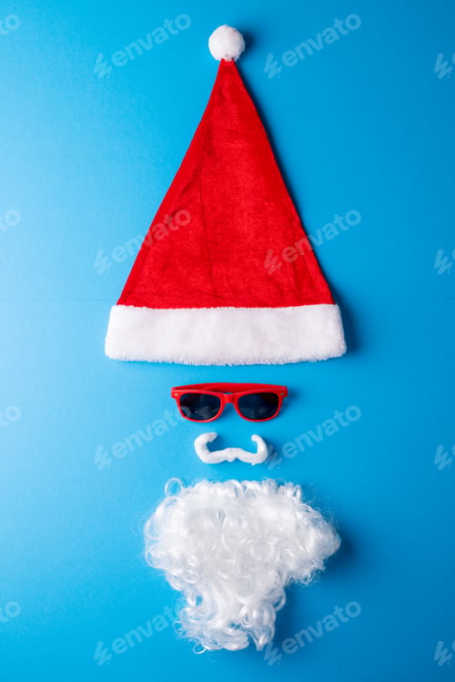 Preview: Image of christmas decoration with santa claus hat and copy space on blue background