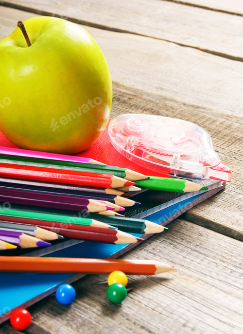 Preview: School tools. On wooden background.