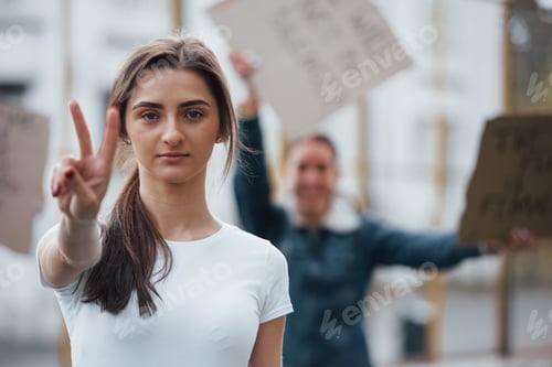 Preview: Two fingers gesture. Group of feminist women have protest for their rights outdoors