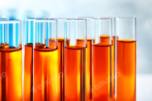 Preview: Many test tubes with orange liquid, closeup