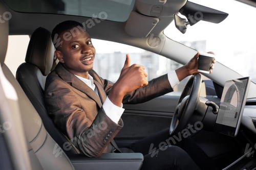 Preview: African man businessman, sitting in his new high tech electric car