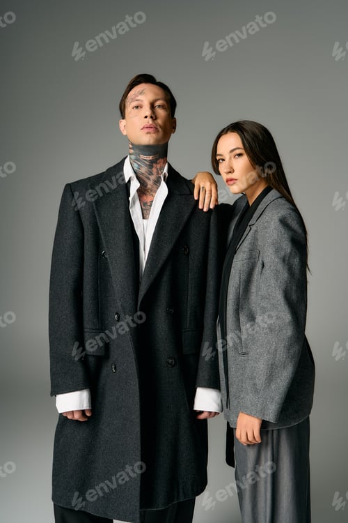 Preview: Young couple in stylish fashion outfits poses confidently in a modern studio setting