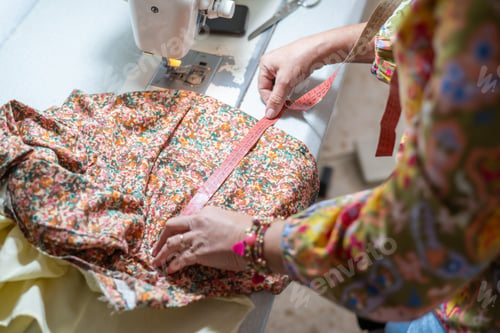 Preview: Seamstress measuring fabric during handmade dressmaking process