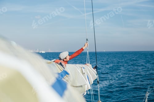 Preview: Sailor works on deck of sailboat or yacht