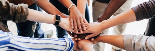 Preview: Group of diverse people stacking hands in the middle