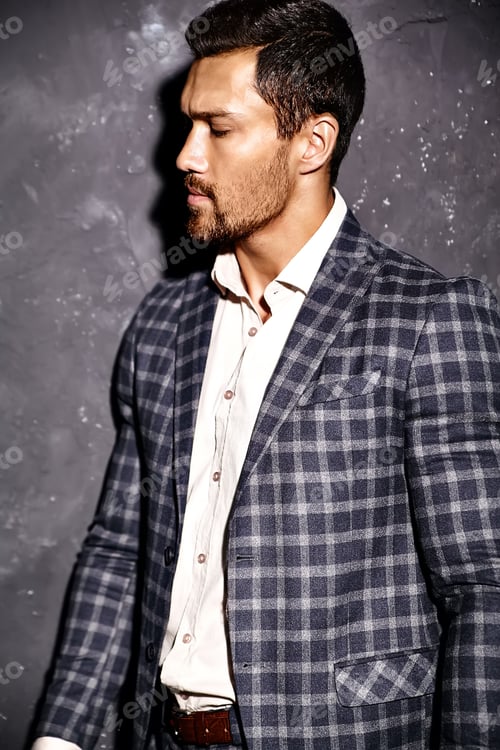 Preview: Portrait of young handsome man in suit posing in studio