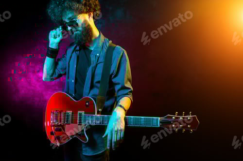 Preview: Man with a Guitar in Colorful Lighting