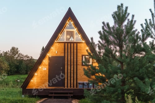 Preview: The concept of glamping and renting a chalet for weekend. Wooden house with a veranda