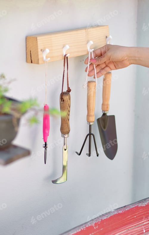 Preview: Gardening Tools Hanging on White Wooden Hooks