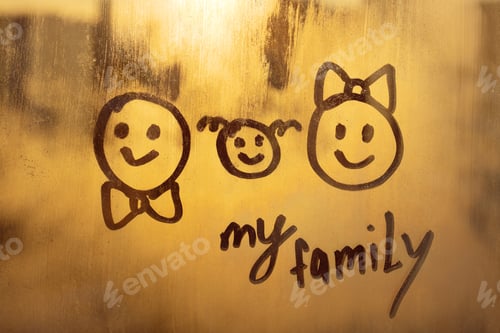 Preview: three doodle smile and handwritten lettering text My family on foggy glass sunset window