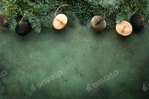 Preview: Christmas composition. Christmas fir tree branches with pine cones and papers rustic balls on old gr