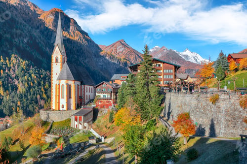 Preview: Astonishing autumn landscape at Heiligenblut with St Vincent Church near Grossglockner mount .