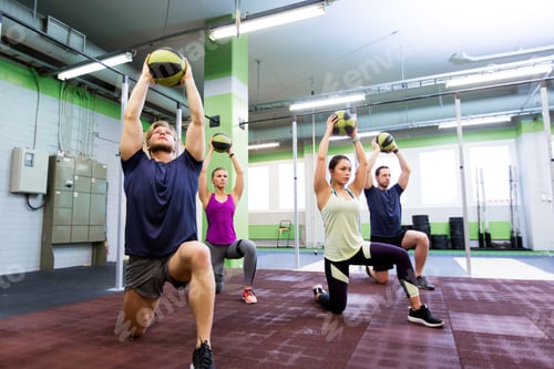 Preview: group of people with medicine ball training in gym
