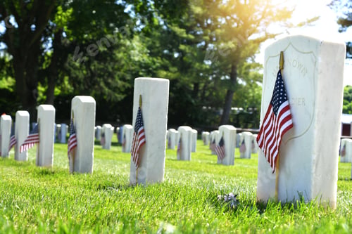 Preview: Rows of grave stones in a National cemetery decorated with American flags for Memorial Day.