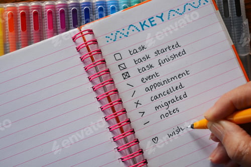 Preview: Bullet Journal, woman starting a neatly inked notebook...