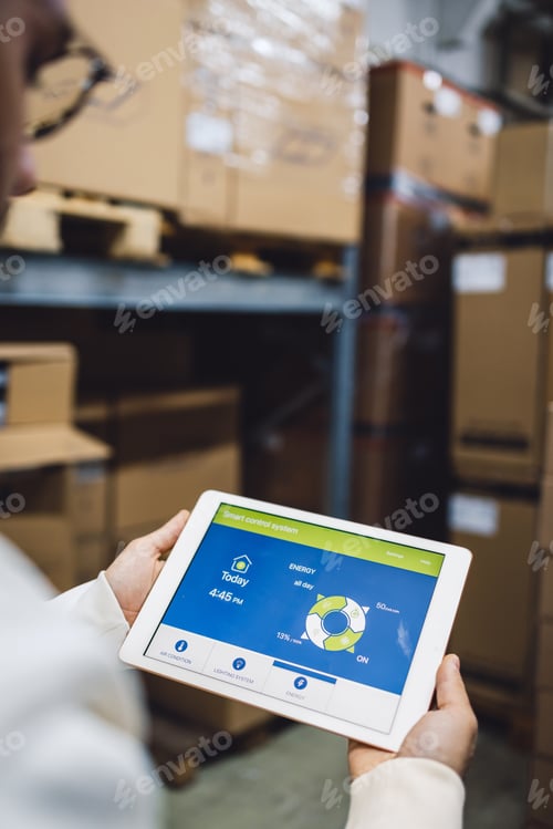 Preview: The young female owner and the man in the warehouse check the temperature, energy consumption and li