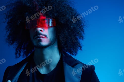 Preview: Fashion portrait of a man with curly hair on a blue background wearing red sunglasses, multinational