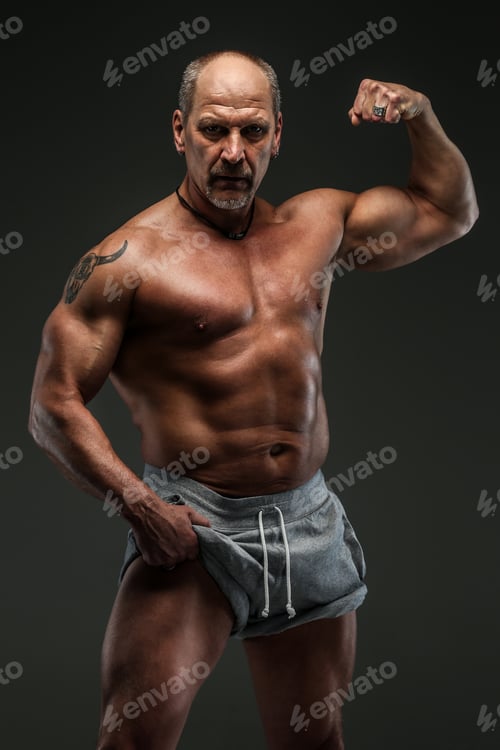 Preview: Muscular middle age man showing his muscules