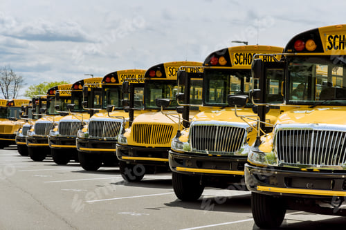 Preview: Yellow school buses parked near the high school