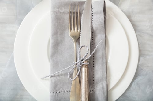 Preview: Holiday table place setting with plates, fork and knife, top view