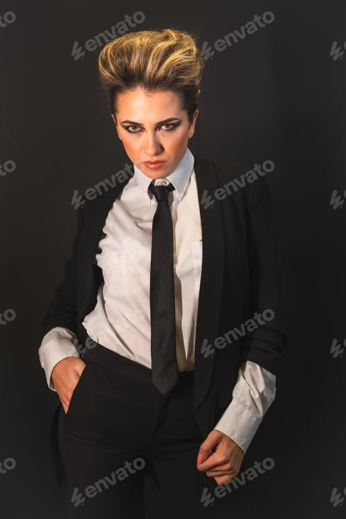 Preview: A sexy young blonde hair female in a black suit posing at camera
