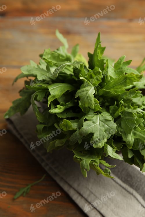 Preview: Fresh arugula on wooden table, closeup view