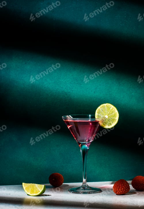 Preview: Lychee alcoholic cocktail drink with vodka, gin, lime and ice, dark green background, hard light