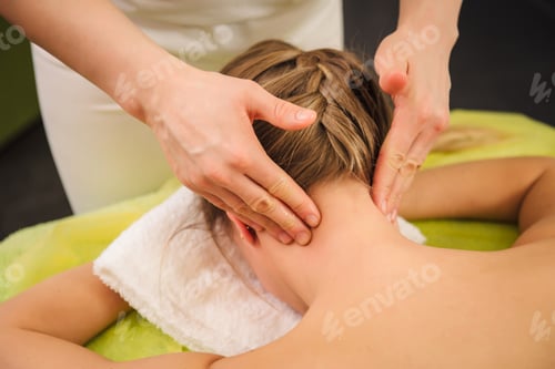 Preview: Classical neck and shoulder massage. Beautiful woman enjoying a treatment in a spa center. Body and