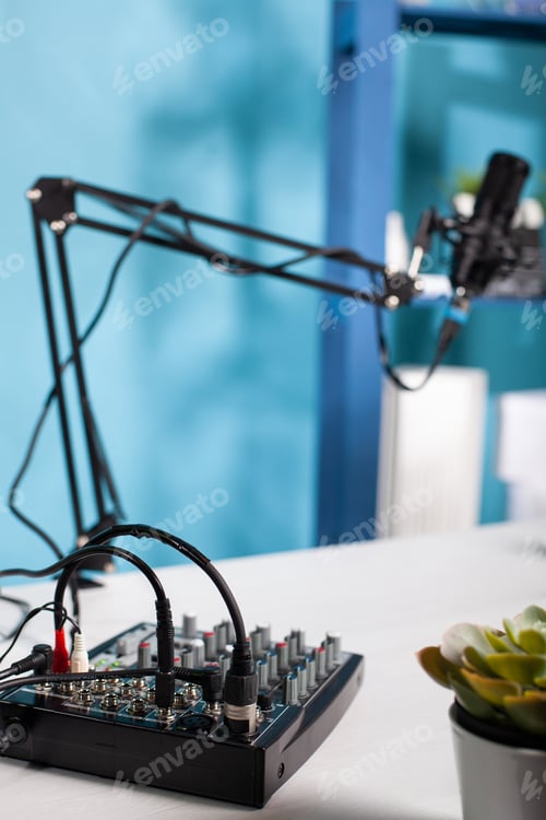 Preview: Professional audio mixer used for recording audio podcast on desk in empty vlog studio