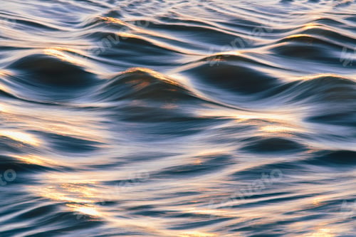 Vista previa: Sunlight reflecting on small waves on the ocean surface.