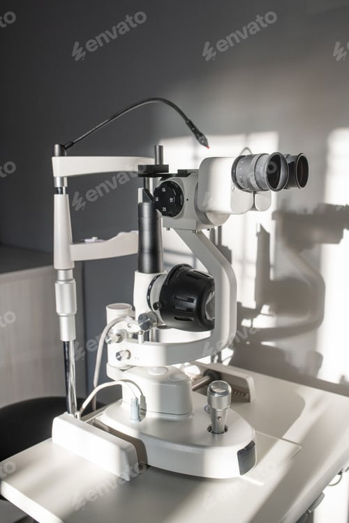 Preview: Ophthalmological diagnostic equipment on small table by white wall in clinics