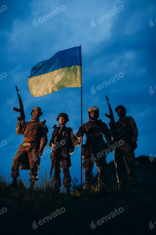 Preview: A group of armed Ukrainian soldiers posing for camera with a national flag
