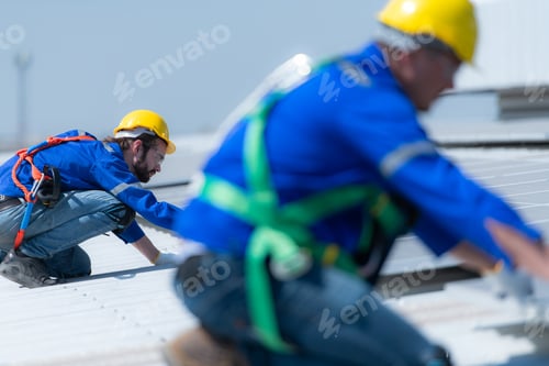 Preview: Both of technicians is installing solar panels on the roof of the warehouse