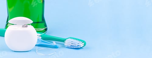 Preview: Banner with dental floss, toothbrush and mouthwash on blue background