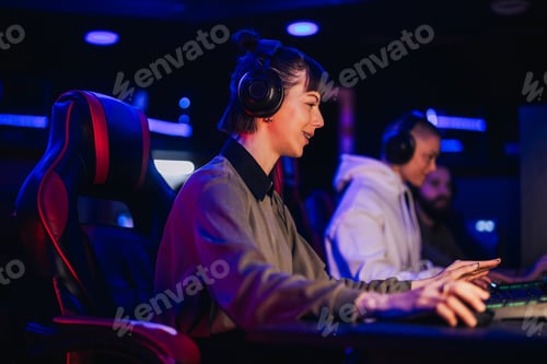 Preview: Woman with headphones playing online video game on an esport tournament