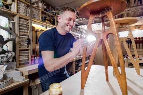 Preview: Craftsman polishing wooden stool with oil finish