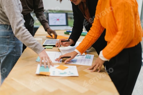 Preview: Business people analyzing charts and reports during meeting