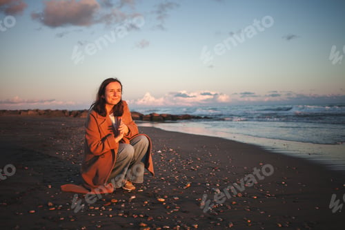 Preview: Lady enjoys tranquil beach walk.