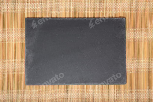 Preview: Blank Black slate Tray isolated on bamboo tablecloth background