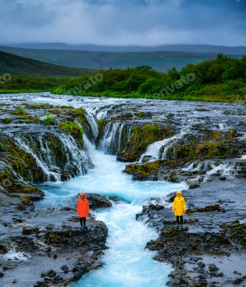 Preview: Iceland. A team of travelers is walking near the river. A couple of girls take a walk in nature.