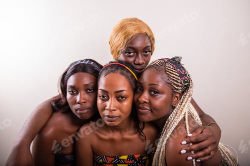 Preview: Four African women with serious expressions look towards the camera, studio shot with copy space