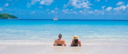 Preview: Anse Lazio Praslin Seychelles, young couple men and woman on a tropical beach during a luxury
